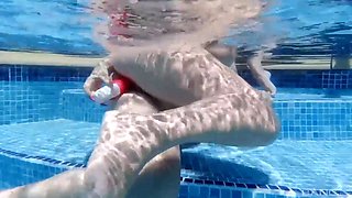 Three horny lesbian girls with big tits have fun playing with their dildo in the swimming pool