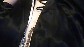 The bitch is fucking her cunt deeply with a hard glass dildo
