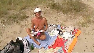 mature voyeur masturbates and sucks on beach