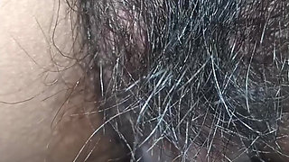 Close up view on a hairy and creamy pussy