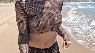 On a public beach, while walking in a transparent blouse, I meet a stranger