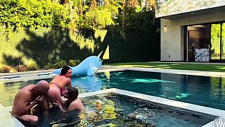 In a kitchen a sexy brunette playing with her big boobs