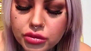 Tattooed blonde lady with a bubble gum