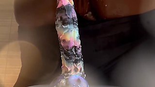 Busty ebony slut stains the camera squirting as she rides a dildo