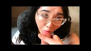Chubby Asian girl with glasses milks a dick with her mouth