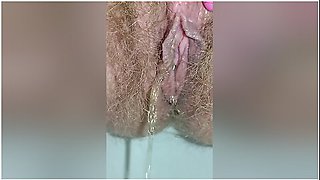 Detailed Close-up Footage Of A Hairy Pussy Girl Urinating From Her Pee Hole And Farting Loudly