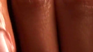 Oiled ebony babe masturbates with her fingers and toy in a close up video