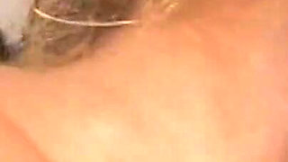 Sexy blonde with glasses sucks his dick in close up
