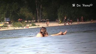 Beach nudist couple having sex in water on voyeur cam