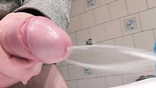 Close up side view soft dick peeing a hard steady jet of pee
