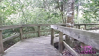 Sexy redhead streaks naked in a park