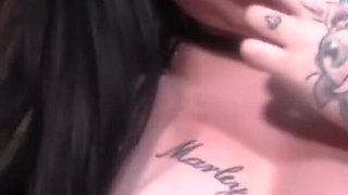 Busty tattooed chick jerks off a big dick