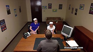 Head teacher blown by two by his desk