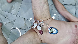 CBT, games with electricity. Dominatrix Nika connected an electrostimulator to the cock and balls of her BDSM slave.