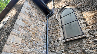 Rea kneels behind the church to suck me off