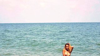 Smoking hot nude teen posing in the sand