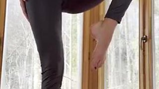 Petite yoga instructor. Bare feet, Nylon leggings