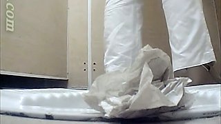 White chick in white pants pisses in the public toilet room on cam