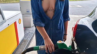 She Is Refueling at the Gas Station, Showing Her Tits and Pussy