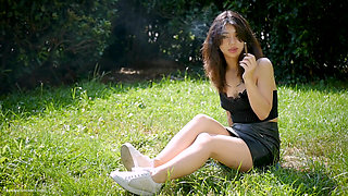 Arina Is Smoking One Black Cigarette Outdoors