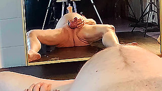 Fuck Machine thrusts long cock down my throat, so I gag and pee, then I kneel and jerk off for the cameras