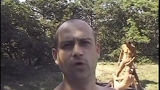 Bisexual stud gets his ass fucked by a dude while fucking a brunette babe on the grass