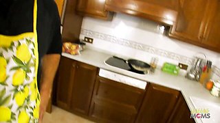 Dark hair brunette in leopard print robe and black lace lingerie teases in tiled kitchen