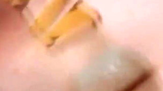 Curly-haired Babe Masturbates with Bottle in Hot Tub