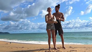 Tattooed hottie and her partner are naked on the beach
