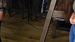 Slave Mila's Feet Dangle and Quiver as Mistress Baton Breaks in Heavy Wooden Paddle Over Her Jeans and Bare