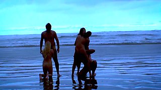 Big ass on the beach with several naked women having sex