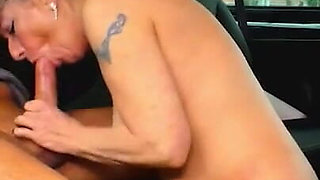 Tattooed Milf blows huge cock in the car and rides it on