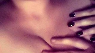 A super sexy brunette massages her big boobs