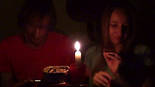 Couple Smoke Next to Candle