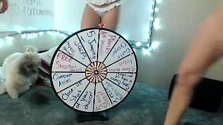 In a kitchen a sexy brunette playing with her big boobs