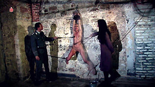 Hanging at the Wall with Her Legs Spread Wide Apart the Female Prisoner Is Made Hot by Lashes