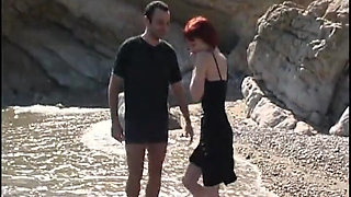 Young couple film a romantic fuck on a beach