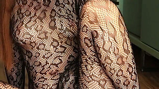 I'm Posing in a Black Fishnet Bodysuit and Heels, Pleasuring Myself with My Fingers.