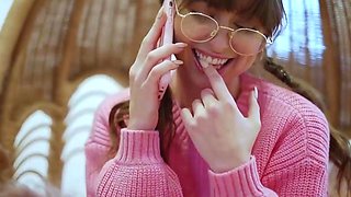 Brunette female in pink sweater likes a phone kink