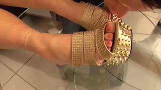 Mistress lets her slave lick her golden shoes