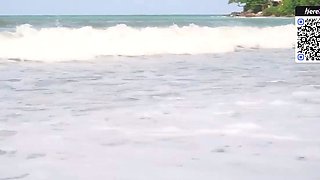 Brown haired doll in a bikini on the beach