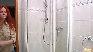 Redhead beauty showering solo