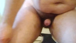 Guy sitting on the floor jerks off cumming and tasting his cum