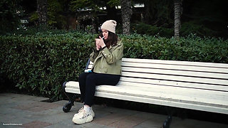 Young Brunette Is Taking an Unhurried Stroll with Allwhite 120mm Cigarette