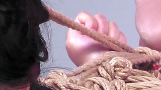 Miwa Kiritani with Her Back Arched in a Controlled Bondage Session