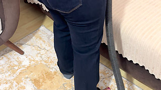 Curvy woman cleaning the house in trousers