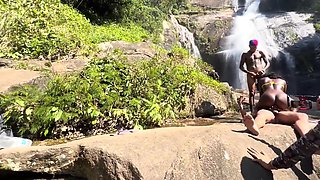 Black hottie got her holes busy with two cocks on a waterfall