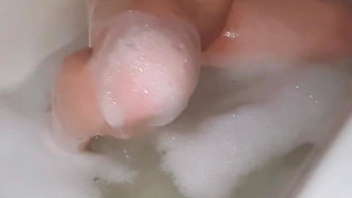 Young babe sucking and masturbating in the bathtub with a dildo