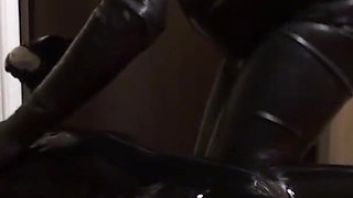 Oil body in latex catsuit