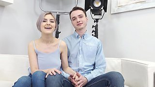 A Tiny Teen rides a big cock in a steamy scene